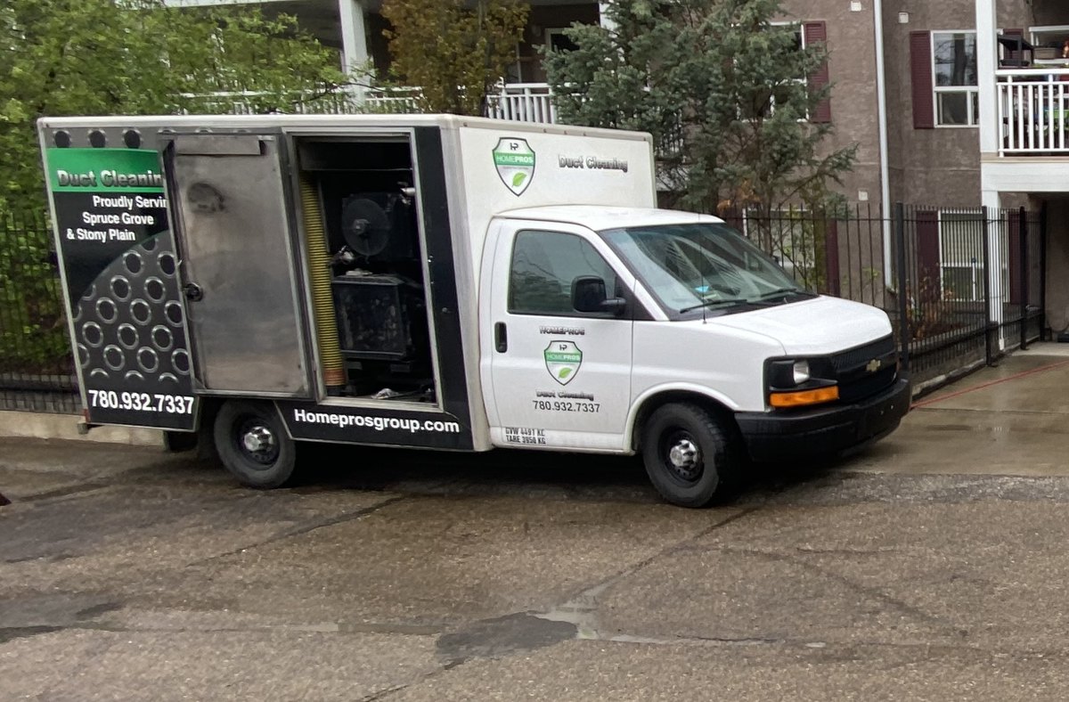Home Pros Group duct cleaning truck with its vacuum unit doors open, lettered "Proudly Serving Spruce Grove & Stony Plain"
